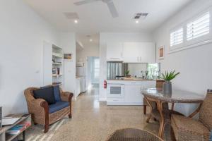 a kitchen and living room with a table and chairs at East Woonona Sea Esta Studio in Woonona