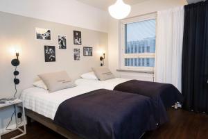 Кровать или кровати в номере Lietsu Boutique Aparthotel - Huoneistohotelli Lietsu