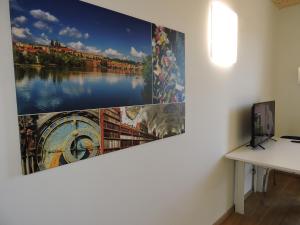 a painting hanging on a wall next to a desk at 213 Prag, Studio Apartment, 27m2, 1-2 Personen in Klagenfurt