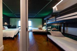 a bedroom with two bunk beds and green walls at The ReMIX Hotel in Paris