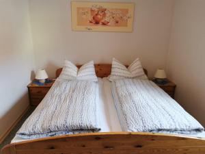 a bedroom with two beds with white blankets at Ferienhaus-Haidweg-Wohnung-2 in Haidmühle