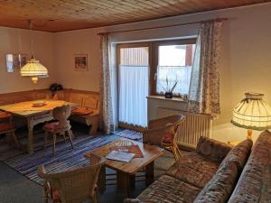 a living room with a couch and a table at Ferienhaus-Haidweg-Wohnung-2 in Haidmühle