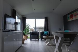 un soggiorno con scrivania e un soggiorno con finestra. di CS 34 - Vakantiepark Callassande a Callantsoog