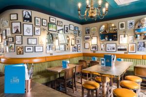 a restaurant with tables and photos on the wall at Aragon House in London