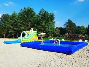a group of people playing in a water park at Firlej Plaża in Firlej