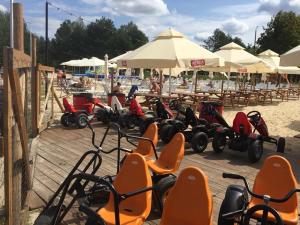 a bunch of scooters are lined up on the beach at Firlej Plaża in Firlej