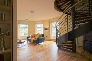 a living room with a couch and a wine cellar at 93a Grey Street Apartments in Newcastle upon Tyne