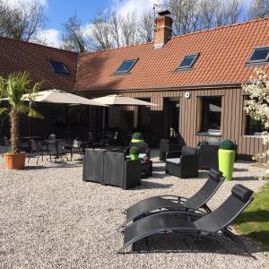 a group of chairs and tables in a courtyard at Le Domaine de Wail - Legends Resort in Wail