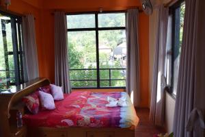 a bedroom with a bed and a large window at Siddhartha Garden Ayurveda in Pokhara