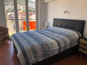 a bedroom with a large bed with a large window at F4 120 m2 10 minutes à pieds du vieux nice in Nice