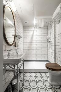 a bathroom with a toilet and a sink and a mirror at Aragon House in London