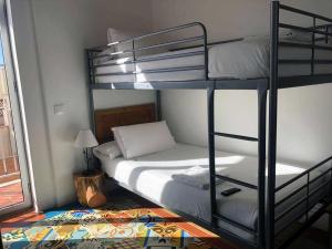 a bedroom with two bunk beds and a lamp at Pigal in Tarragona