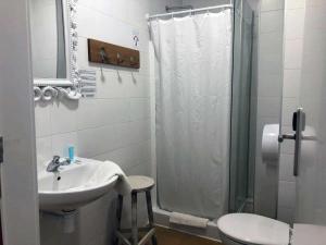 a bathroom with a sink and a shower and a toilet at Pigal in Tarragona