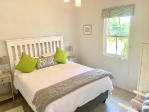 
a bedroom with a bed and a window at Paul Wallace Wines & Cottages in Elgin
