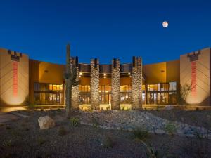 a large building at night with the moon in the sky at Desert Diamond Casino in Tucson