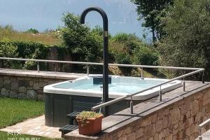 a hot tub in a brick wall with aumbing at Villa Siresola in Malcesine
