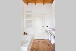 a white bathroom with a tub and a sink at Villa Siresola in Malcesine +33 photos