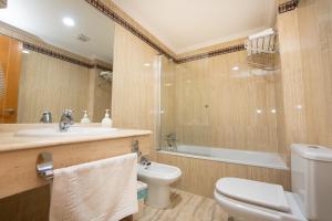 a bathroom with a toilet and a sink and a shower at Apartamentos Jimmy in Nerja +19 photos