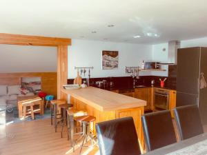 a kitchen with a table and chairs in a room at Boost Your Immo Les Deux Alpes 185 in Les Deux Alpes
