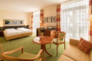 a hotel room with a bed and a living room at Hotel Buerer Hof in Gelsenkirchen