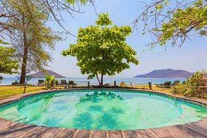 a swimming pool with a view of the water at Mgoza Lodge in Cape Maclear