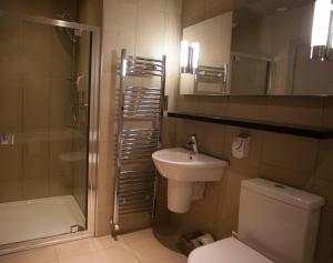 a bathroom with a sink and a toilet and a shower at The Marine Hotel in Stonehaven