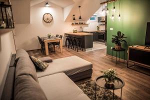 a living room with a couch and a kitchen at Soul House Omiš in Omiš