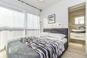 Postel nebo postele na pokoji v ubytování Apartments Solis Lacus Penthouse