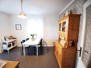 eine Küche und ein Esszimmer mit einem Tisch und einem Fenster in der Unterkunft Apartments Poldi in Bled