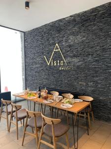 a table with chairs and a sign on a wall at Vista Gudauri in Gudauri