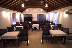 a dining room with tables and chairs and a room with at Colonia Santa Maria, A Club M Associate in Baga