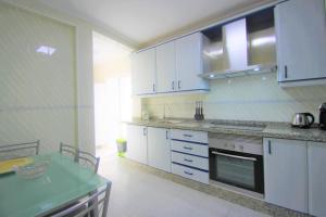 a kitchen with white cabinets and a green counter top at CasaTuris Rambla Méndez Núñez en el corazón de Alicante A109 in Alicante