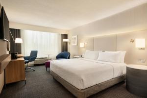 a hotel room with a bed and a desk and chair at Crowne Plaza Hotel Philadelphia - King of Prussia by IHG in King of Prussia +52 photos