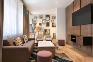 a living room with a couch and a tv at Crowne Plaza Hotel Philadelphia - King of Prussia by IHG in King of Prussia