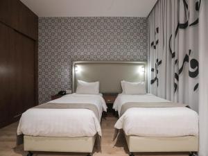Voodi või voodid majutusasutuse La Locanda Boutique Hotel toas