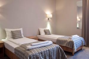 Postel nebo postele na pokoji v ubytování Hotel Jan Sander