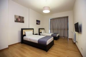 A bed or beds in a room at Kantari Suites