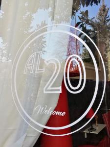 a store window with a sign that reads all welcome at Al 20 Guest House Fiera Milano - Certosa - San Siro in Milan