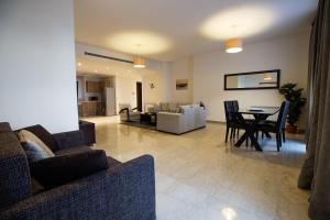 a living room with a couch and a table with chairs at Kantari Suites in Beirut