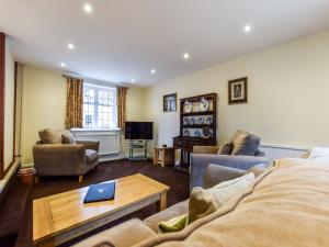 a living room with a couch and a table at Anne Boleyn in Winchcombe