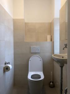 a small bathroom with a toilet and a sink at Hotel Pension Schmellergarten in Munich