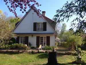 een wit huis met een raam en een tafel bij Azuré Chambres d'hôtes in Orgeval