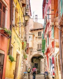 a group of people walking down a narrow alley at Hotel Casa Garzotto in Rovinj
