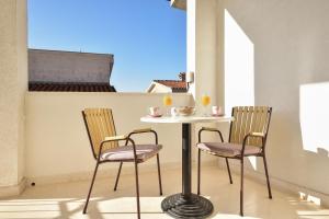 a table and two chairs sitting on a balcony at Apartments Makarska Gudelj Cvitan in Makarska