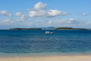 a boat in the middle of a large body of water at Cocotinos Sekotong Lombok in Sekotong