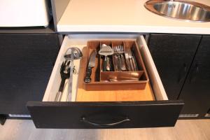 a drawer in a kitchen with utensils in it at Lofoten Camp in Stamsund