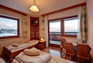 ブコビナ・タトシャンスカにあるDom Wypoczynkowy Orełkiのベッド2台と窓2つが備わる客室です。