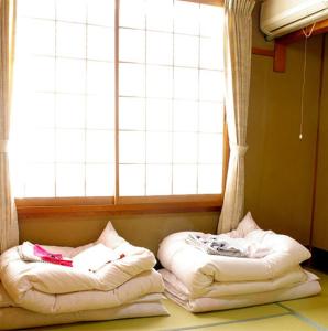 Posteľ alebo postele v izbe v ubytovaní Daiya Ryokan