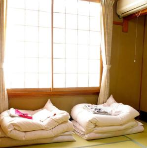 Postel nebo postele na pokoji v ubytování Daiya Ryokan
