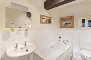 Un baño blanco con lavabo e inodoro. en River View, en York
